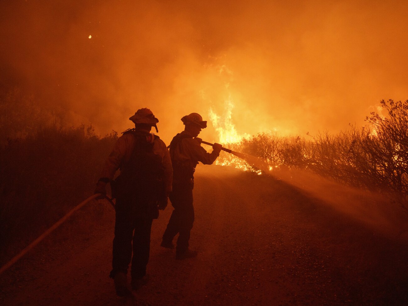 Firefighters work against the advancing Post Fire on Sunday in Gorman, Calif.