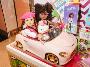 Dolls are displayed inside a toy car at American Girl Place.