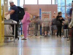 Passengers move through the main security checkpoint at Kansas City International Airport on June 3.