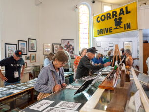 Melissa Talmadge Cox (left), Buster Keaton's granddaughter, looks at photographs from the filming of <em>The General</em> along with conference attendees.