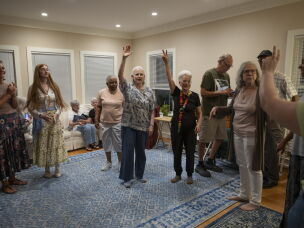 Former residents and friends of Anne Montgomery House prepare to dance a traditional Greek dance at the home's farewell celebration in Washington, D.C., on July 31, 2026.