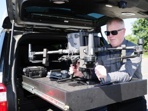 Chief Warrant Officer Kevin Fennessy lifts an Ocean County Sheriff's Office DJI Matrice 300 RTK drone out of the custom-built bed of a department SUV at Robert J. Miller Airpark on Sept. 4.