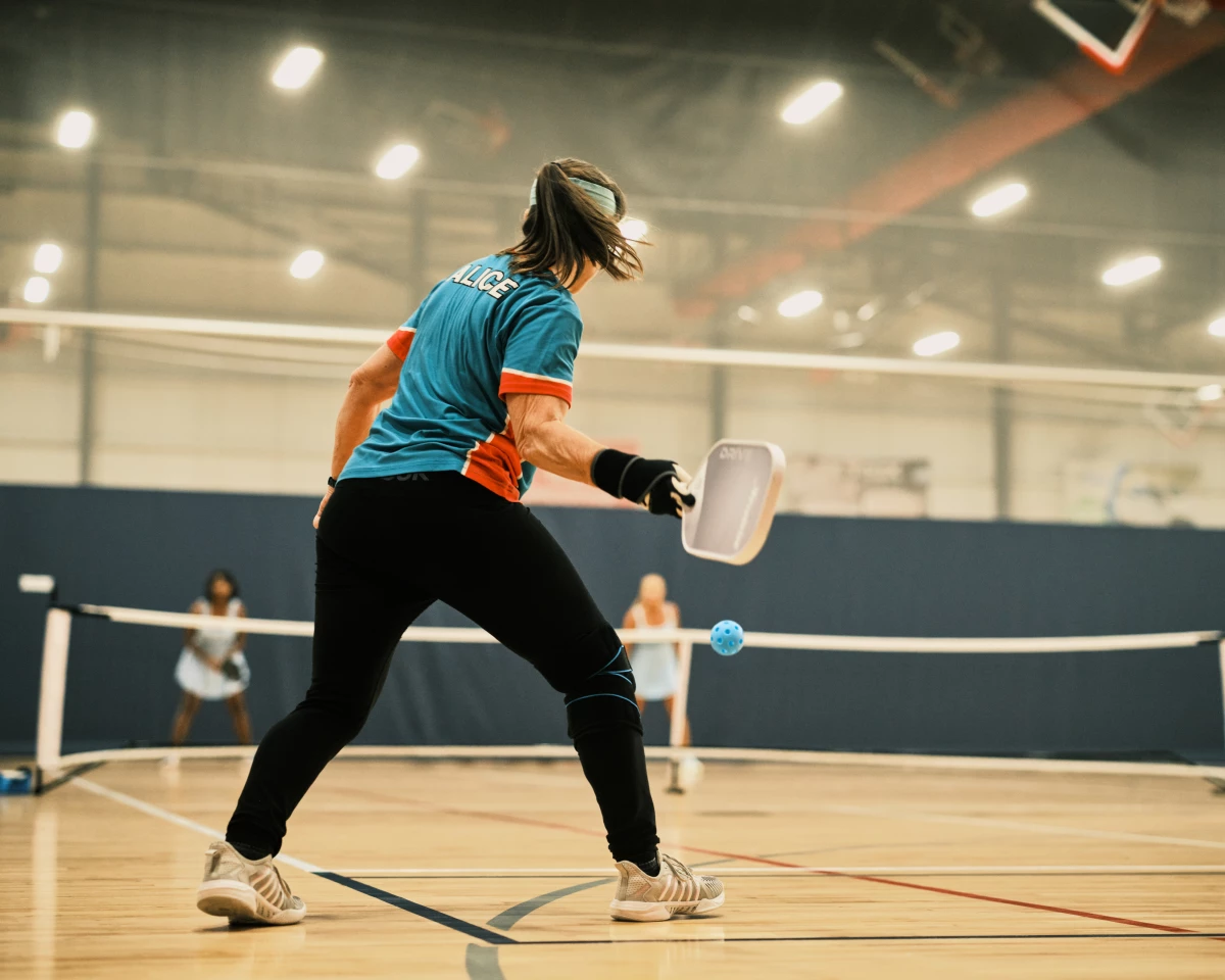 Pickleball player Alice Edington, 56, returns the ball to her opponents during a doubles match at the Florida Senior Games. Pickleball is the fastest-growing sport and it's also popular with older athletes.