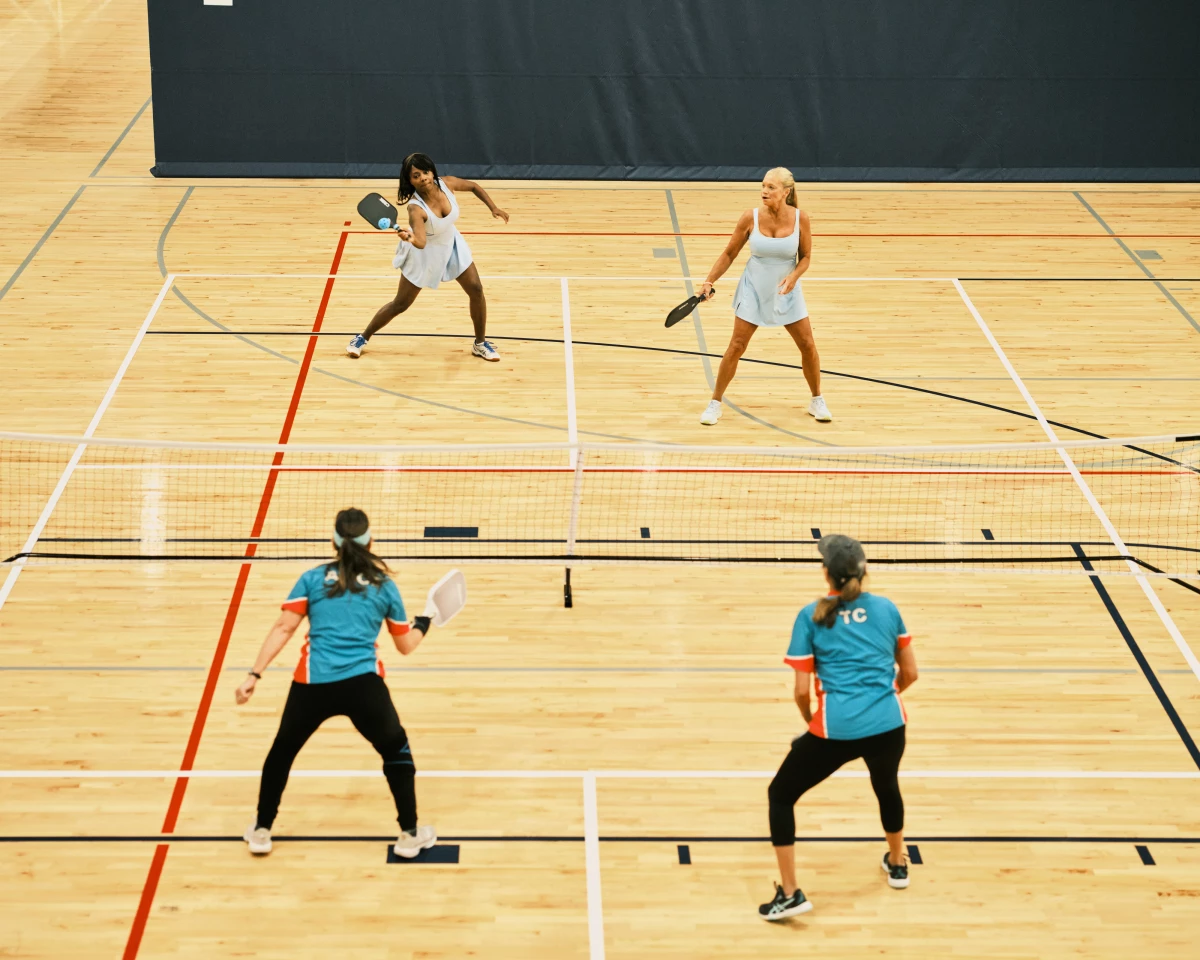 Sondra Boruty, 58, (top left) and Tania Miller, 57, (top right) return the ball to their opponents as they compete in their doubles match at the Florida Senior Games.