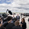Kamala Harris, shown here as vice president in 2022, speaks to the traveling press pool as second gentleman Doug Emhoff looks on, under the wing of Air Force 2 at Buffalo-Niagra International Airport.