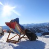 For Pagans, winter solstice is a time for reflection and celebration : NPR 3 Two people sit on foldable lawn chairs that are set outdoors on snowy ground. In front of them is a vista of snowy mountains.