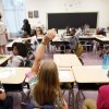 A student raises their hand in a classroom at Tussahaw Elementary school Aug. 4, 2021, in McDonough, Ga. 