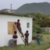 People place plywood over windows as they make last-minute preparations for the arrival of Hurricane Beryl.