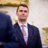 Turning Point USA co-founder Charlie Kirk stands in the back of the room as President Trump speaks during a swearing in ceremony for interim U.S. Attorney for Washington, D.C. Jeanine Pirro in the Oval Office of the White House on May 28.