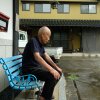 Toshiyuki Mimaki, 83, co-chair of Nihon Hidankyo, a Nobel Peace Prize-winning group of a-bomb survivors in Japan, sits outside his farmhouse, about 10 miles outside the city of Hiroshima.