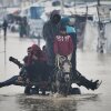 Palestinians cross a flooded street following heavy rain in Khan Younis, southern Gaza Strip, Dec. 11.