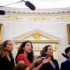 Paintings and gold trim are visible behind reporters as U.S. President Donald Trump holds a swearing in ceremony.