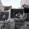 Volunteers clean debris from a residential building damaged when a nearby police station was hit Friday in a U.S.-Israeli strike in Tehran, Iran, Sunday.
