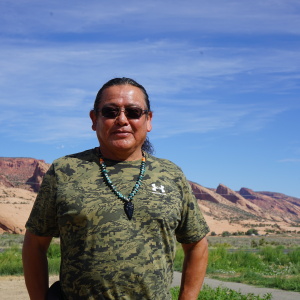 Raymond Peaches stands near where one proposed hydropower project might one day sit on the Navajo Nation. Critics of the project point to questionable tactics used by the developer and his allies as they advocate for the facility.