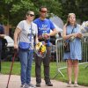 From left, Carrie Spyva-McIlvaine, Gabriel Velasco and Lisa Turnquist arrive to place bouquets of flowers at a memorial after Sunday's attack in Boulder, Colorado.