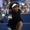 Venus Williams is seen in a close-range action shot, with racket, ball and a look of concentration on her face.