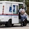 U.S. Postal Service mail carrier Marc Jacques makes a delivery in Miami in March.