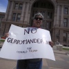 A demonstrator holds a sign saying “NO GERRYMANDERING FOR DONALD TRUMP” outside the Texas Capitol in Austin on Monday as state lawmakers gather for a special session to redraw a map of congressional voting districts.