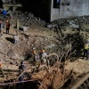 Israeli security forces and rescue teams inspect the crater left by an Iranian missile in Arad, southern Israel, Sunday, March 22, 2026. 