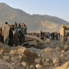 Local residents and civil defense workers look on as a bulldozer clears the rubble of a house hit by a cross-border Pakistani army strike in the Behsud district of Nangarhar province, Afghanistan, Sunday, Feb. 22, 2026.