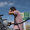 William Mao puts fuel in his vehicle at a gas station in Miami, Florida on April 6.