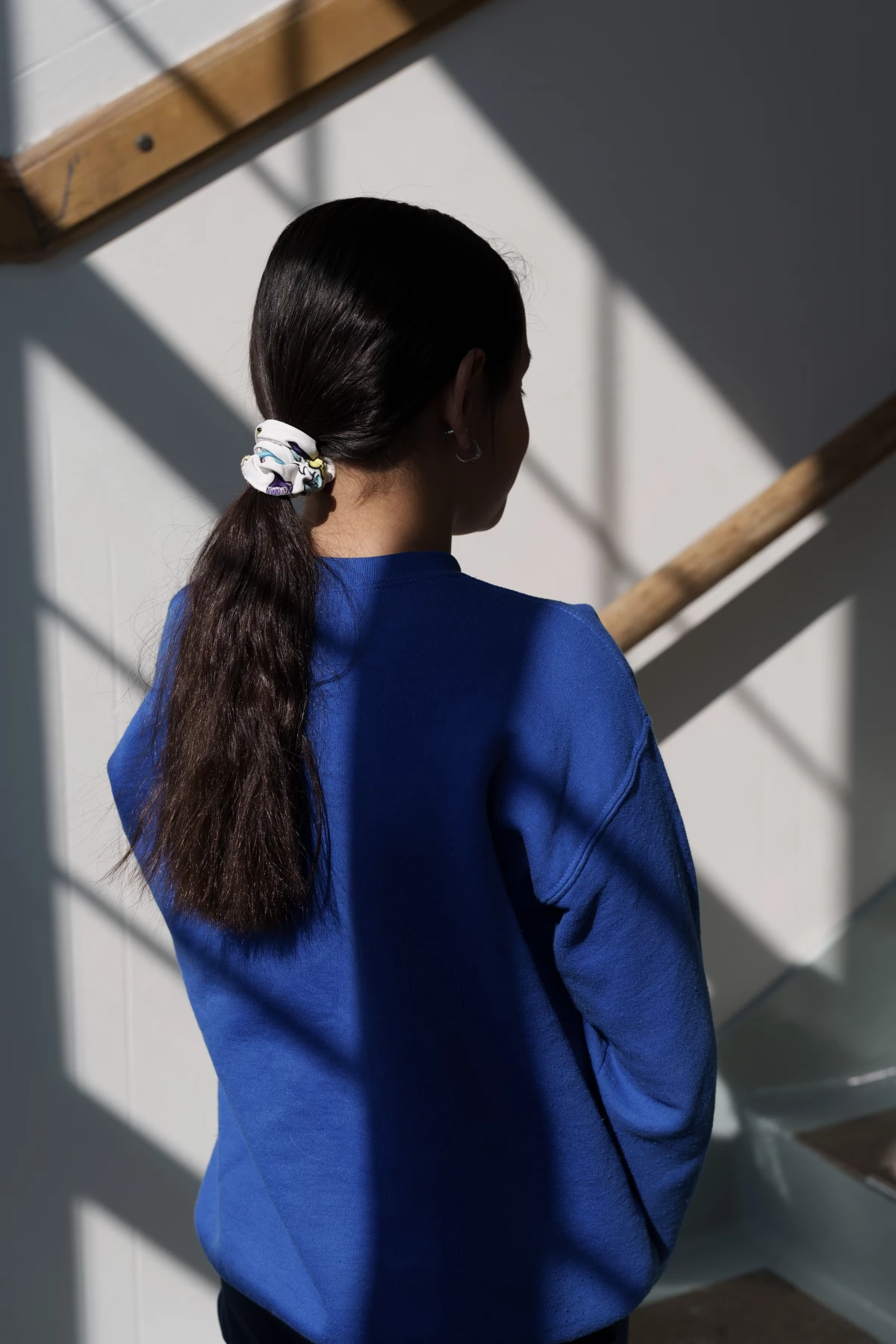 Ellah, the daughter of the principal and a student at the school, stands for a portrait in St. Paul, Minn., on March 18. She did not take the virtual learning option, and was excited when many of her classmates returned to the building.