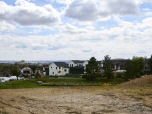 A newly rebuilt home stands next to an empty lot in the Louisville neighborhood. Wildfires are among the climate-related impacts Boulder County cites in its lawsuit against ExxonMobil and Suncor Energy.