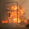 Flames from the Palisades Fire burn a building on Sunset Boulevard amid a powerful windstorm on Jan. 8 in the Pacific Palisades neighborhood of Los Angeles, California.