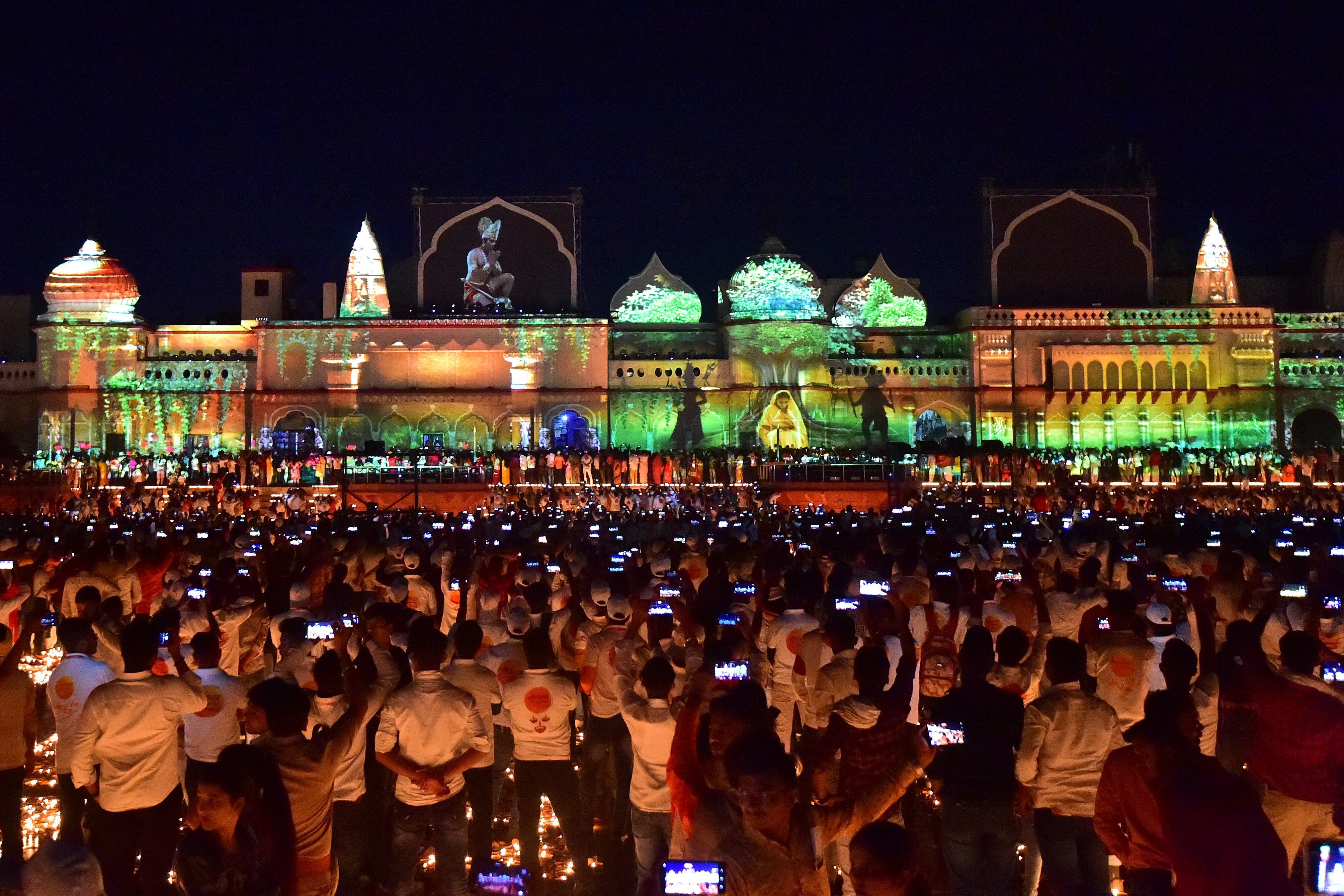 People watch a light show on the banks of river Sarayu on the eve of Diwali, the Hindu festival of lights, in Ayodhya on Oct. 23, 2022.