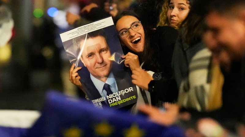 Supporters of presidential candidate Nicusor Dan celebrate on the street after polls closed for the second round of the country's presidential election redo in Bucharest, Romania on Sunday.