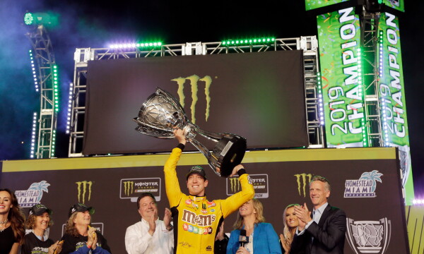In this Nov. 17, 2019, file photo, Kyle Busch holds up the trophy in Victory Lane after winning a NASCAR Cup Series auto racing season championship at Homestead-Miami Speedway in Homestead, Fla. (AP Photo/Terry Renna, File)