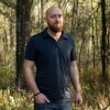 Wade Hanicker stands in a wooded area at his home in Brooksville, Fla.