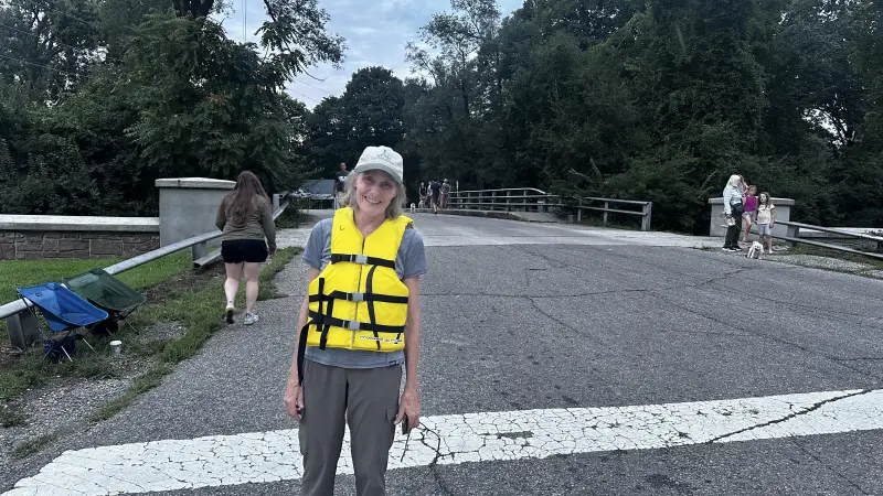 Rocky Ripple resident Margaret Brabant on Saturday, Aug. 15, 2026. She wore a yellow life jacket and directed cars of people who showed up to help, many of whom she said were not from Rocky Ripple.