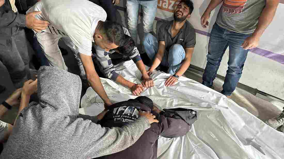 Palestinians grieve relatives who were killed in an Israeli airstrike on an encampment for displaced people on Sunday, May 26, in the southern Gaza city of Rafah. 