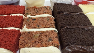 A flight of wedding cake samples at a Publix in Vestavia Hills, Alabama on September 23, 2026. Cake flavors from left to right are red velvet, carrot cake, chocolate and vanilla. Filling flavors from left to right are raspberry; vanilla custard; cookies and cream mouse; and strawberry.