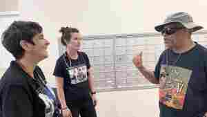 Nurses Lisa Stambolis and Ashley Gresh of the Neighborhood Nursing team talk with Percy Jones. Members of the nursing team visit his apartment building weekly, and Jones credits them with easing his worries about recovering from a hernia surgery when he couldn't get a timely appointment with his doctor.