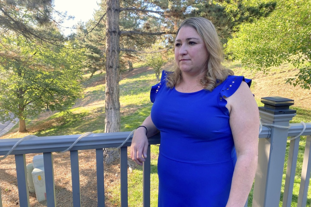 Stephanie Rogers at her mother's home outside Denver, where she and her two young daughters now live. Rogers has dipped into her retirement to help the family get through the federal shutdown. (CPR News)