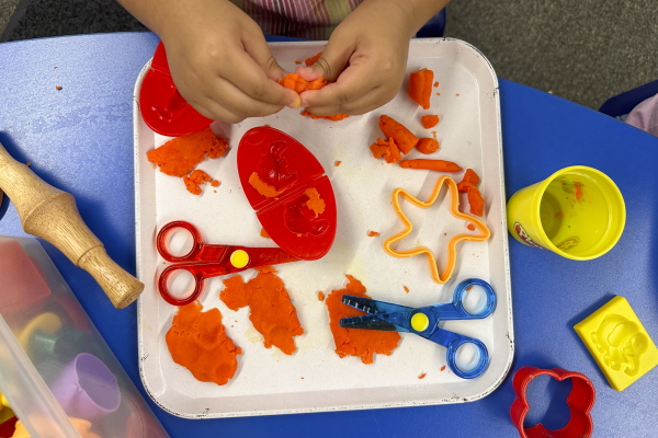 Beck and her longtime assistant sneak lessons into all kinds of activities, including using Play-Doh to practice letter sounds.