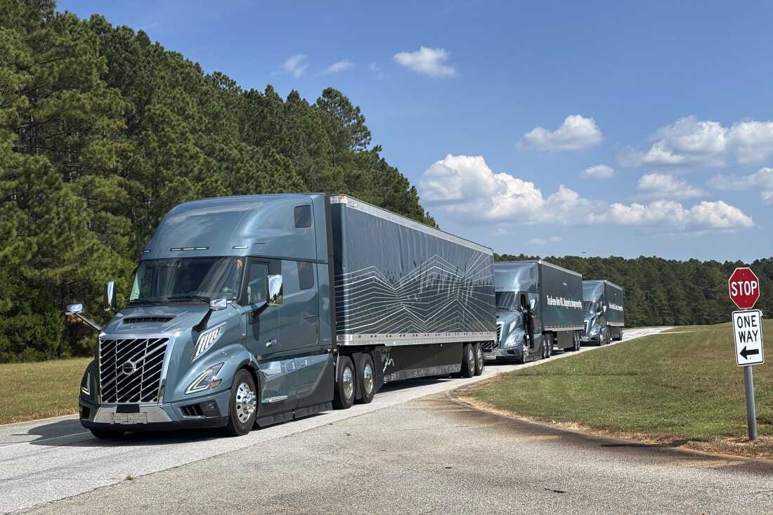 Volvo VNLs lined up at the Michelin Laurens Proving Grounds in South Carolina, waiting to be taken for test rides by members of the media.