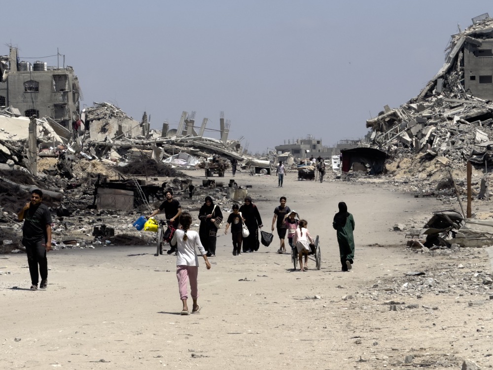 Families leave northern neighborhoods of Gaza City with the few items they can carry on Aug. 26, after Israeli tanks and airstrikes force them out. (NPR)