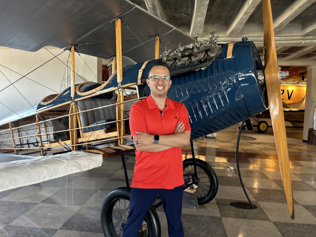 Kansas Aviation Museum president Ben Sauceda stands next to a replica of a Laird Swallow, originally produced in Wichita in the 1920s.