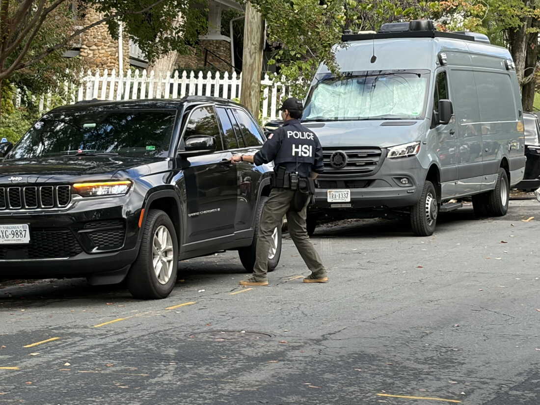 A Homeland Security Investigations agent gets in a car outside the Washington, D.C. residence of Rep. Ilhan Omar, D-Minn., on Monday morning.