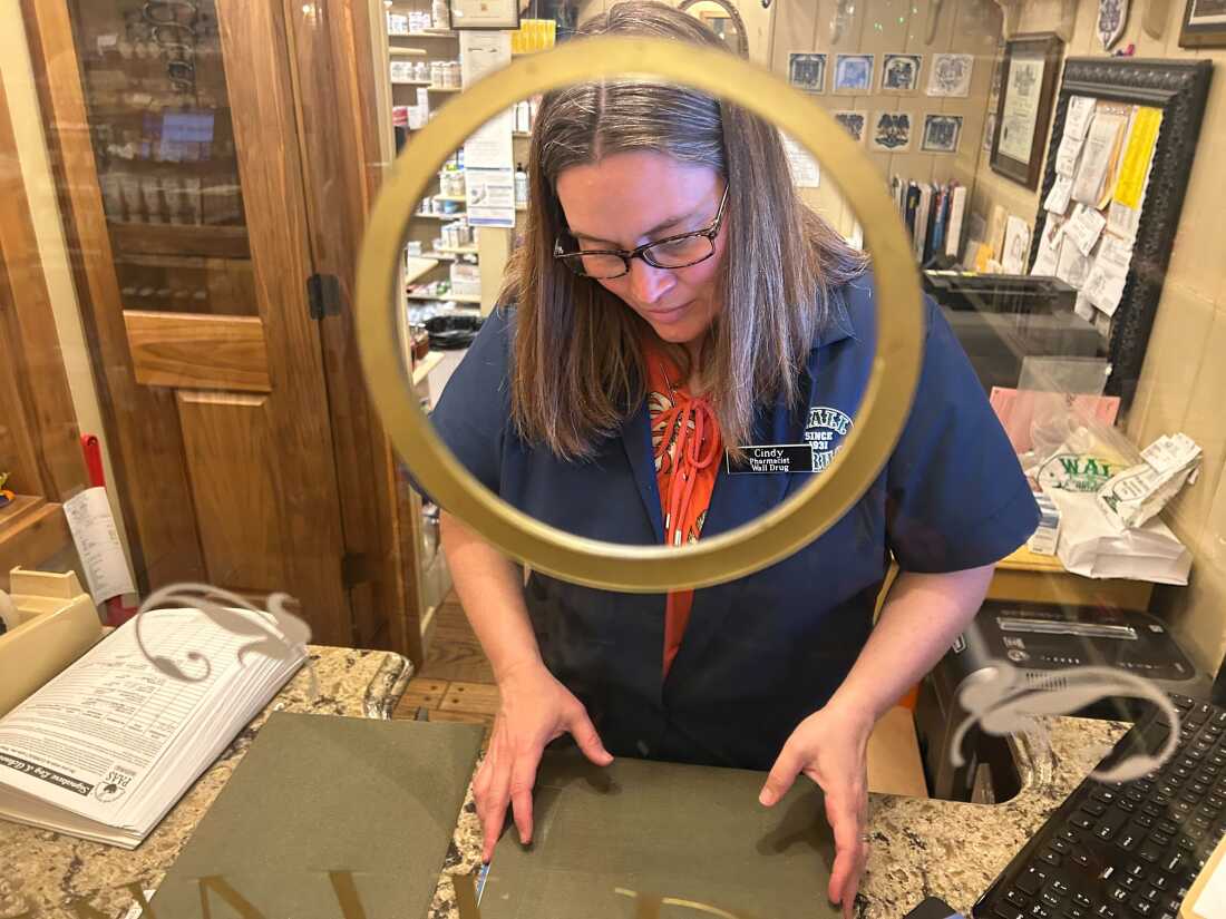 Pharmacist Cindy Dinger says her corner of the store would struggle without the rest of Wall Drug. “All this stuff around us — the poster and print shop, the boot shop, the fudge shop, the café — they pay our bills," she says.