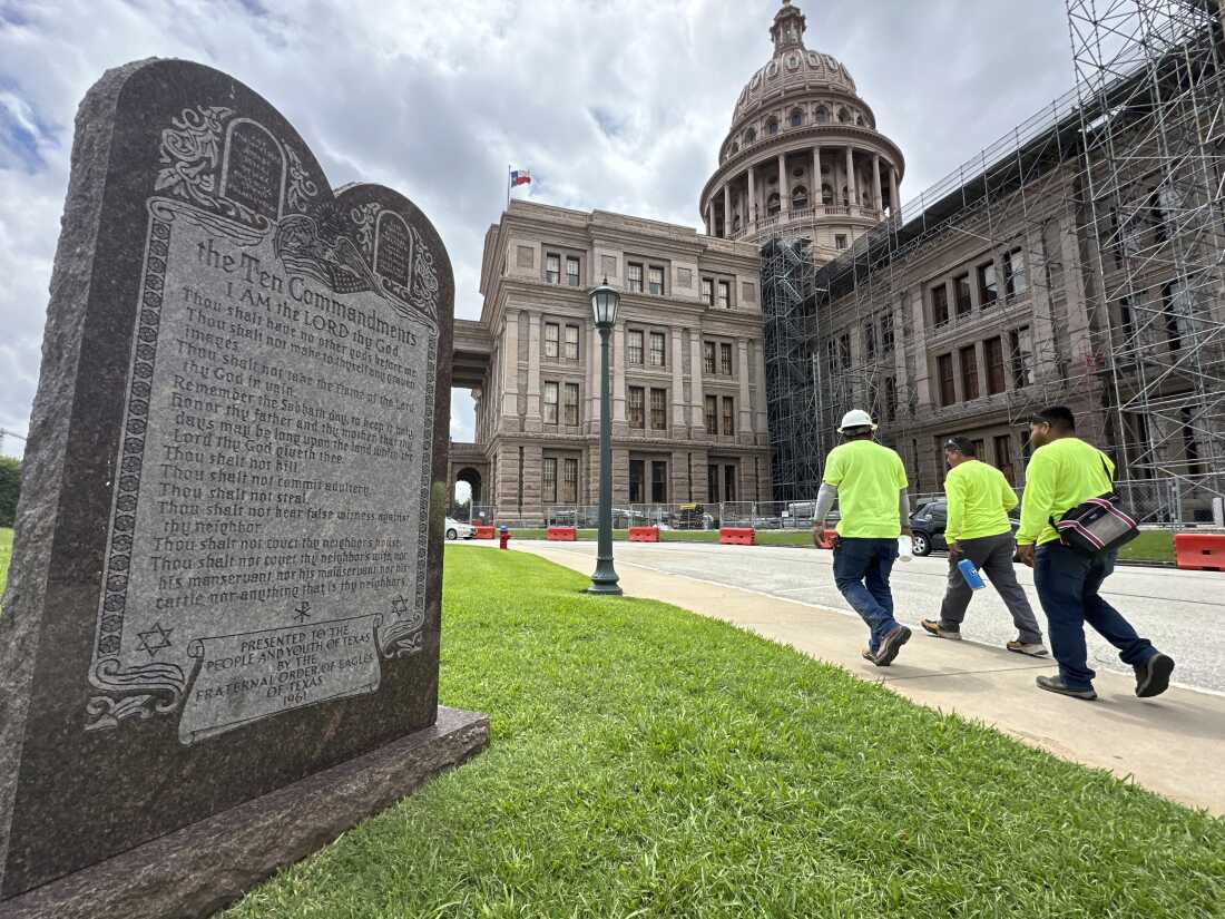 Construction workers walk past a monument of the Ten Commandments outside the Texas Capitol last year.