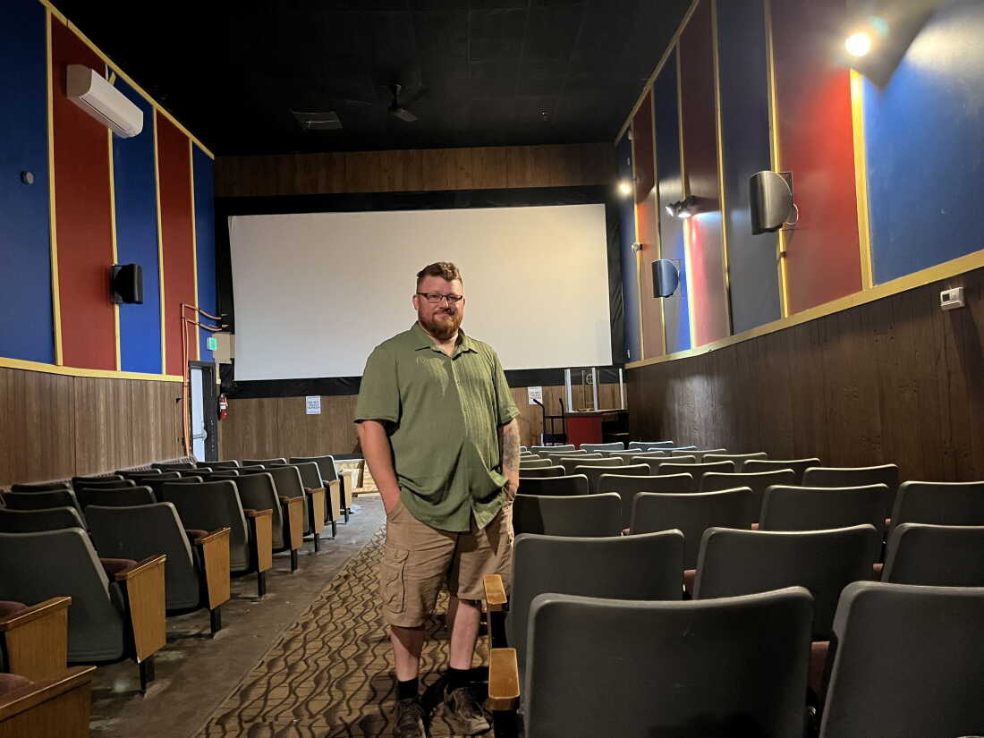 Brandon Goding, 43, stands in the center aisle of one of his two movie auditoriums at Fort Kent Theater.