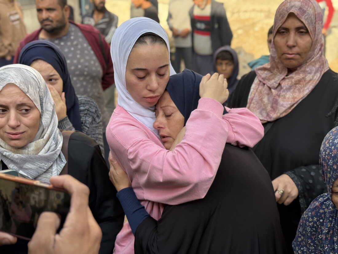 A Palestinian mother is embraced by another woman as mourns her son, who was killed in an Israeli airstrike just over a month into the ceasefire, at Al-Shifa Hospital, in Gaza City, on November 20, 2025.