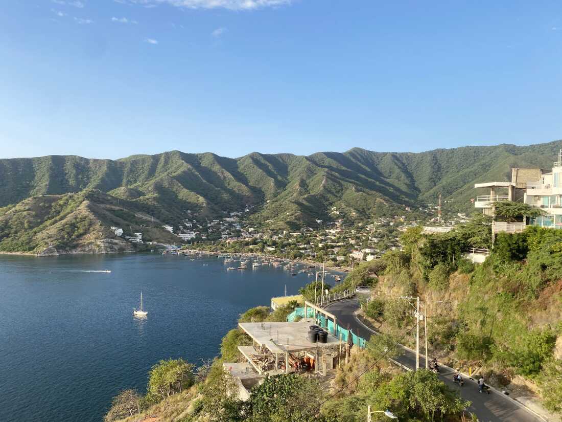 A cove in Colombia where the sea meets green hills.