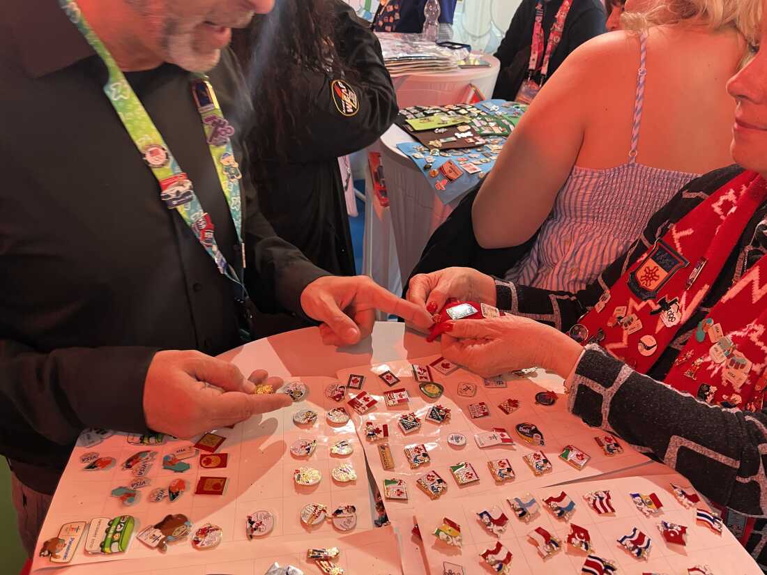 People conducting a trade at a table inside the trading center.