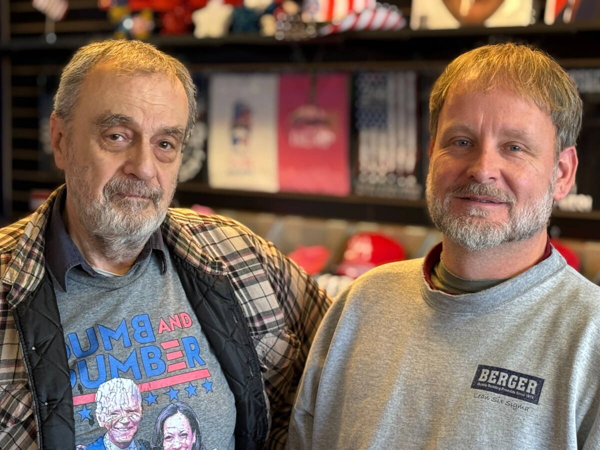 Trump fans Wes Alker and Joseph Flanagan pose at a going-out-of-business sale at a Trump store in suburban Philadelphia. Flanagan lives nearby and said he visited the store more than 25 times.