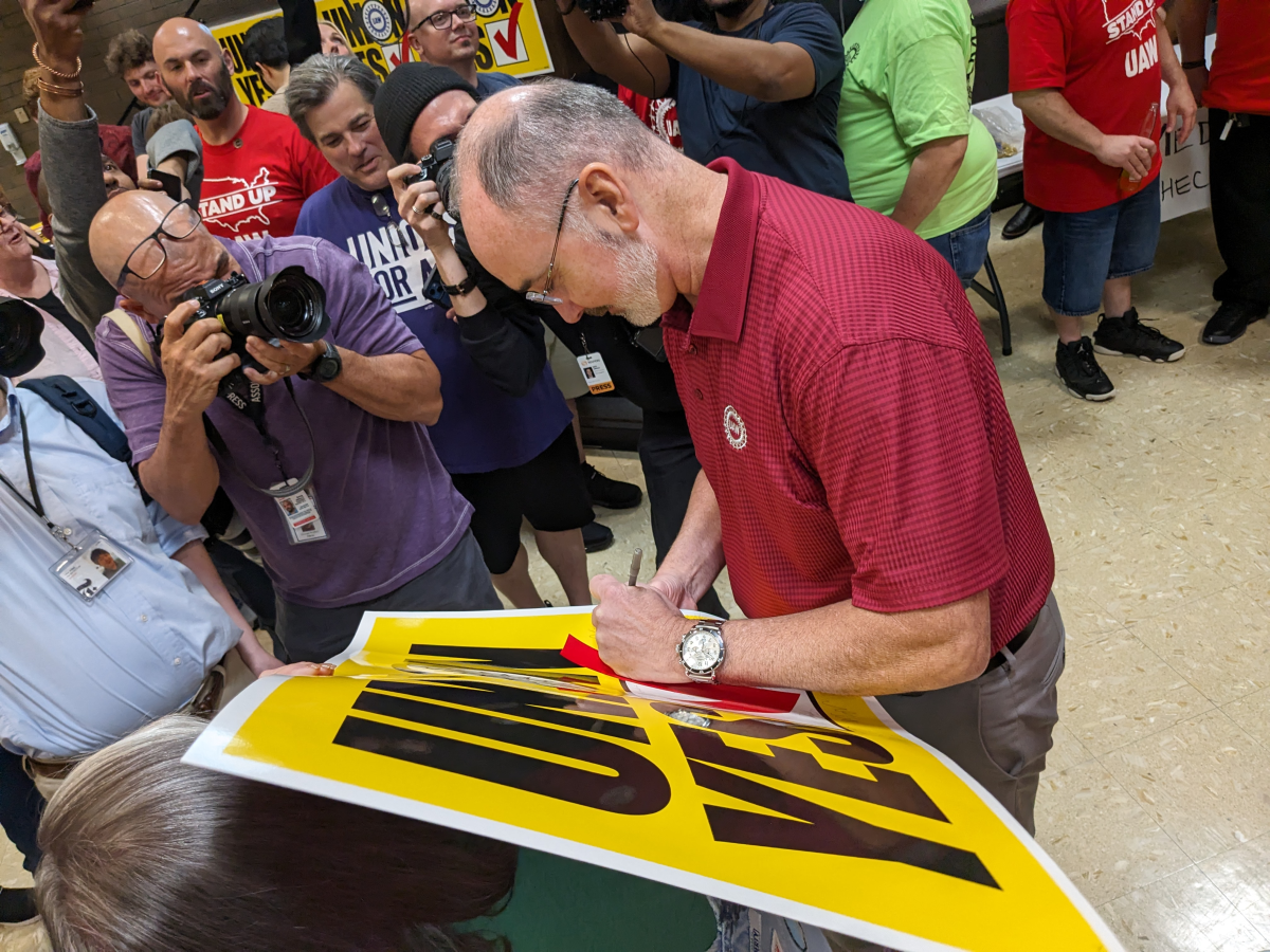 UAW President Shawn Fain signs a 'Union Yes' sign at a watch party in Chattanooga, Tenn. after worker voted to join the UAW on April 19, 2024